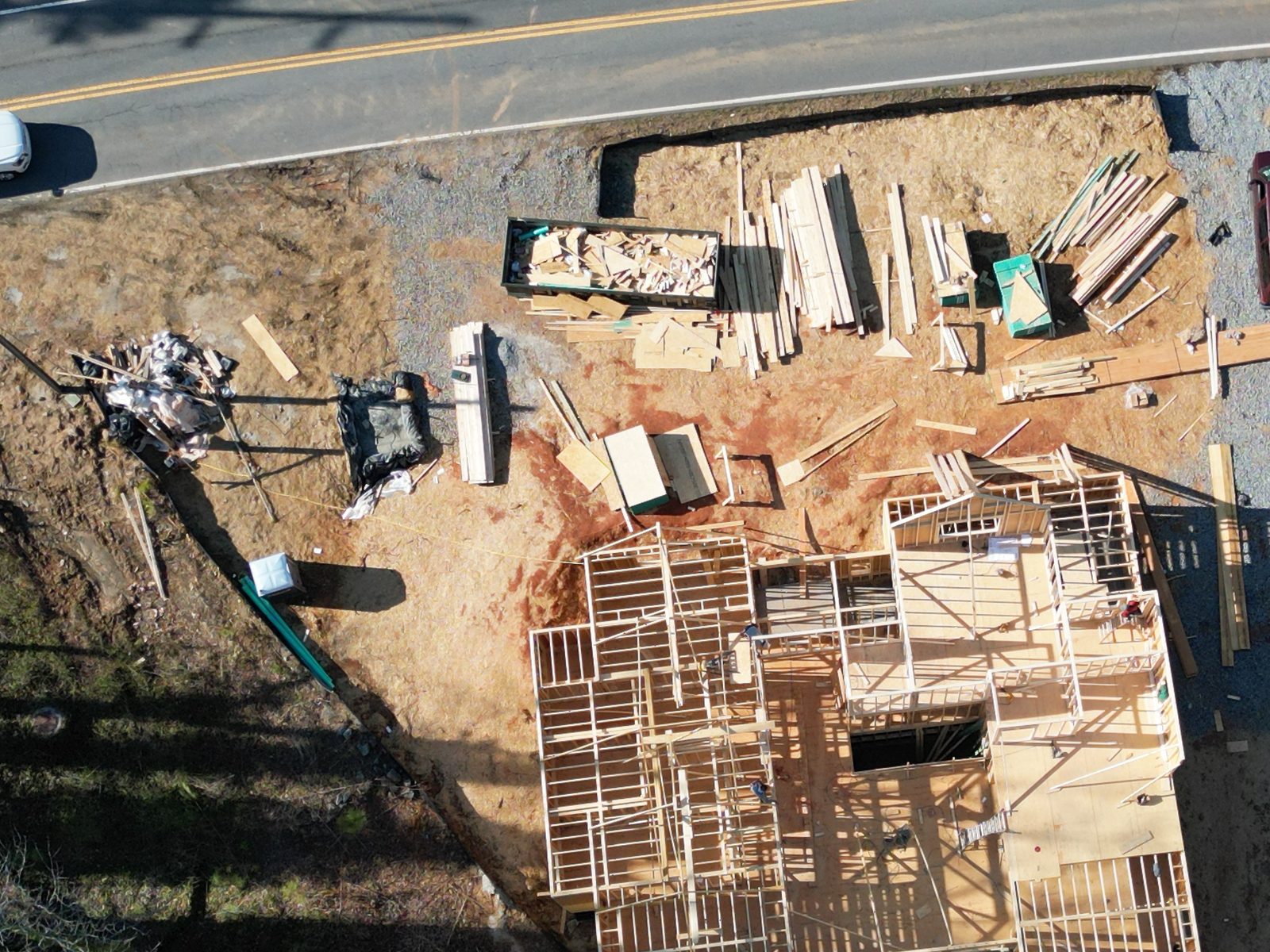 A construction site with framing underway, delivered as a progress report